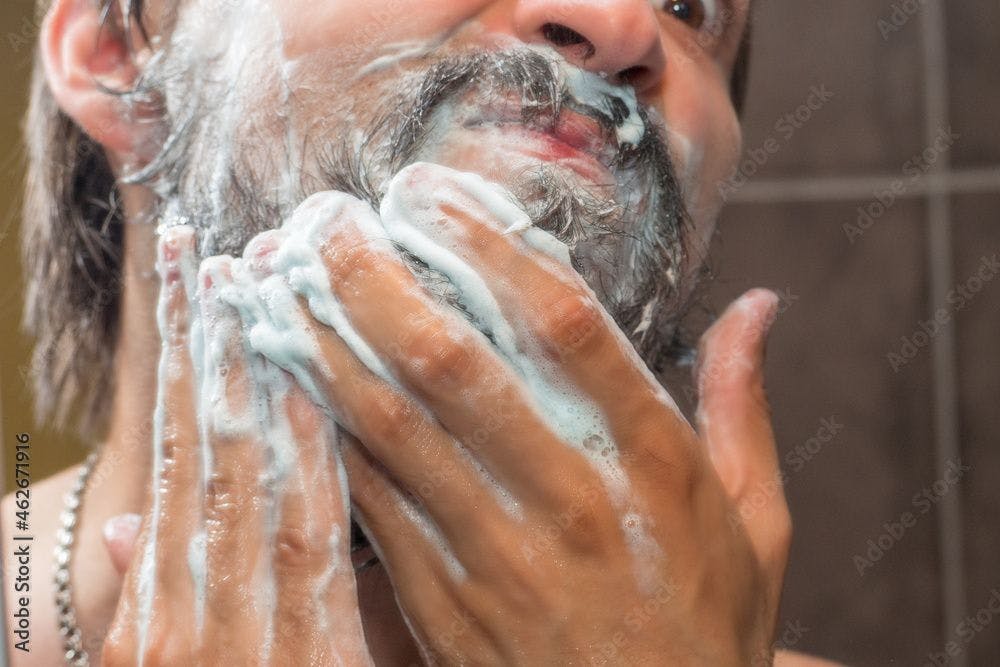 man washing his beard 